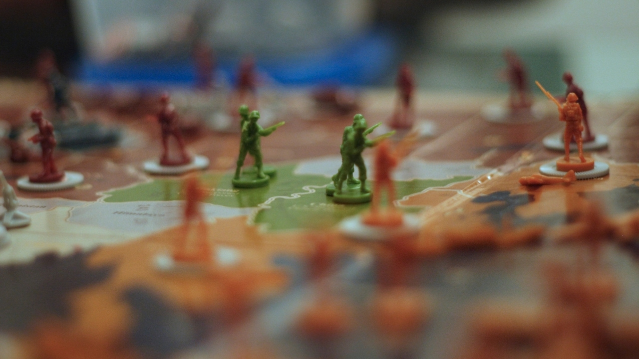 Close-up, focused shot of Axis & Allies game pieces on a game board. 