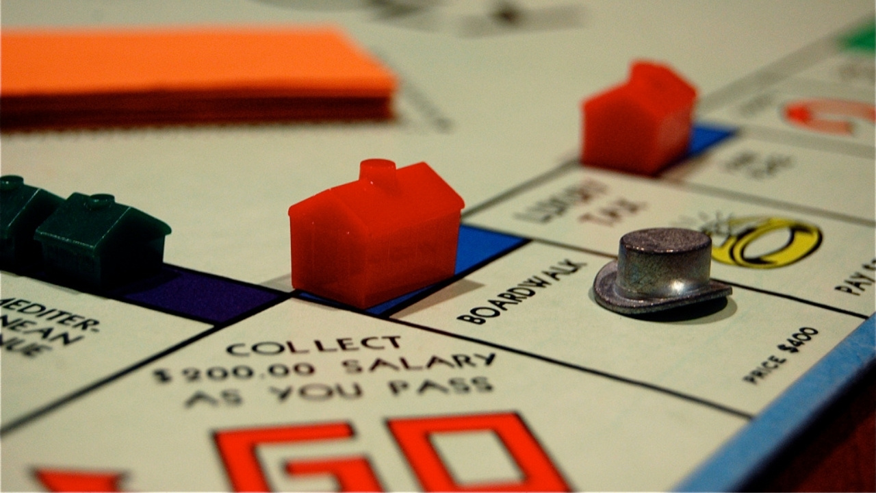 Close-up photo of the Boardwalk and Go spaces on a Monopoly tabletop game board. 