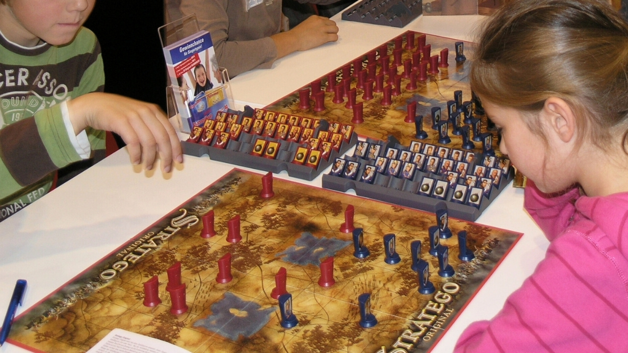 People playing Stratego at a tabletop gaming meetup. 