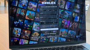PC display shows 'Roblox' login portal.