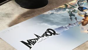 ATLUS x HYTE 'Metaphor: ReFantazio' desk pad in action, shown sitting in front of a computer monitor.