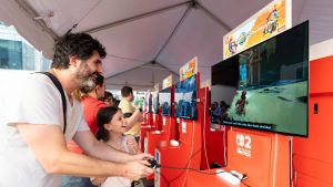 Exciting gamers of varying ages play 'Mario Kart World' at Nintendo's Switch 2 launch event.