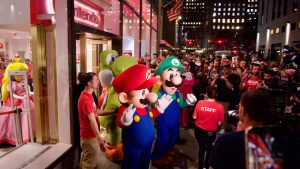 Exterior photo of Nintendo's NYC store during Switch 2 launch celebrations. Mario, Luigi, Peach, Yoshi, and aptly-named brand president Doug Bowser, greet fans.