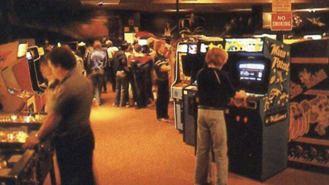 people playing arcade games in aladdin's castle
