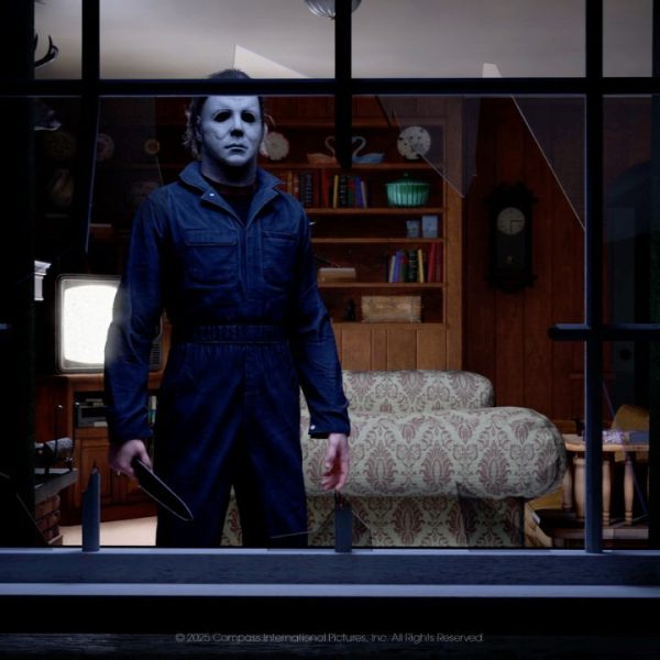 A masked, knife-wielding Michael Myers stares menacingly through a broken living room window (Illfonic's 'Halloween,' 2026)