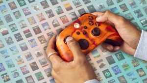 Player holds an orange Xbox controller.