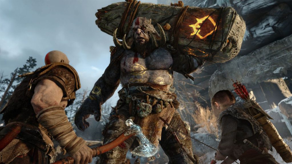Series protagonist Kratos and son Atreus shown with imposing Troll (God of War; 2018)