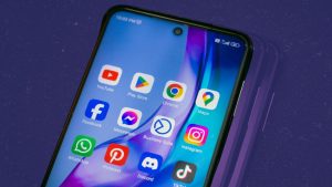 A close-up on smartphone with social media apps installed, including Discord.