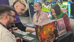 Outrun Gaming's Jake Valentine (L) and Stephanie Valentine (R) play Slay the Spire: The Board Game @ PAX East 2026