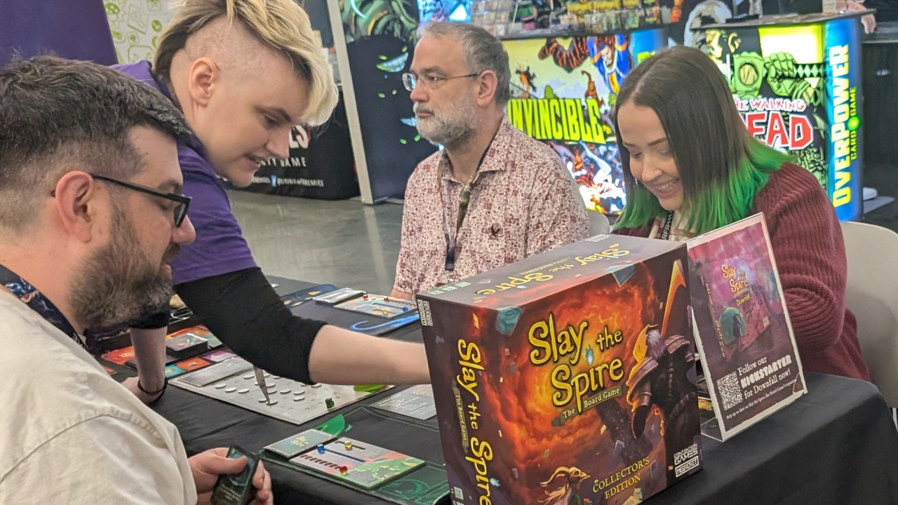 Slay the Spire: The Board Game @ PAX East 2026 🎮 Outrun Gaming Outrun Gaming's Jake Valentine (L) and Stephanie Valentine (R) play Slay the Spire: The Board Game @ PAX East 2026 🎮 Outrun Gaming