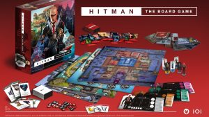 'Hitman: The Board Game' promo image shows game box, game board, cards, tokens, and assorted playable miniatures against red backdrop